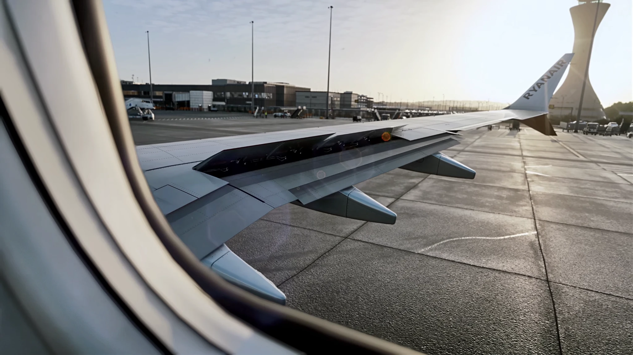 Airport apron and control tower seen from an aircraft window in the simulator